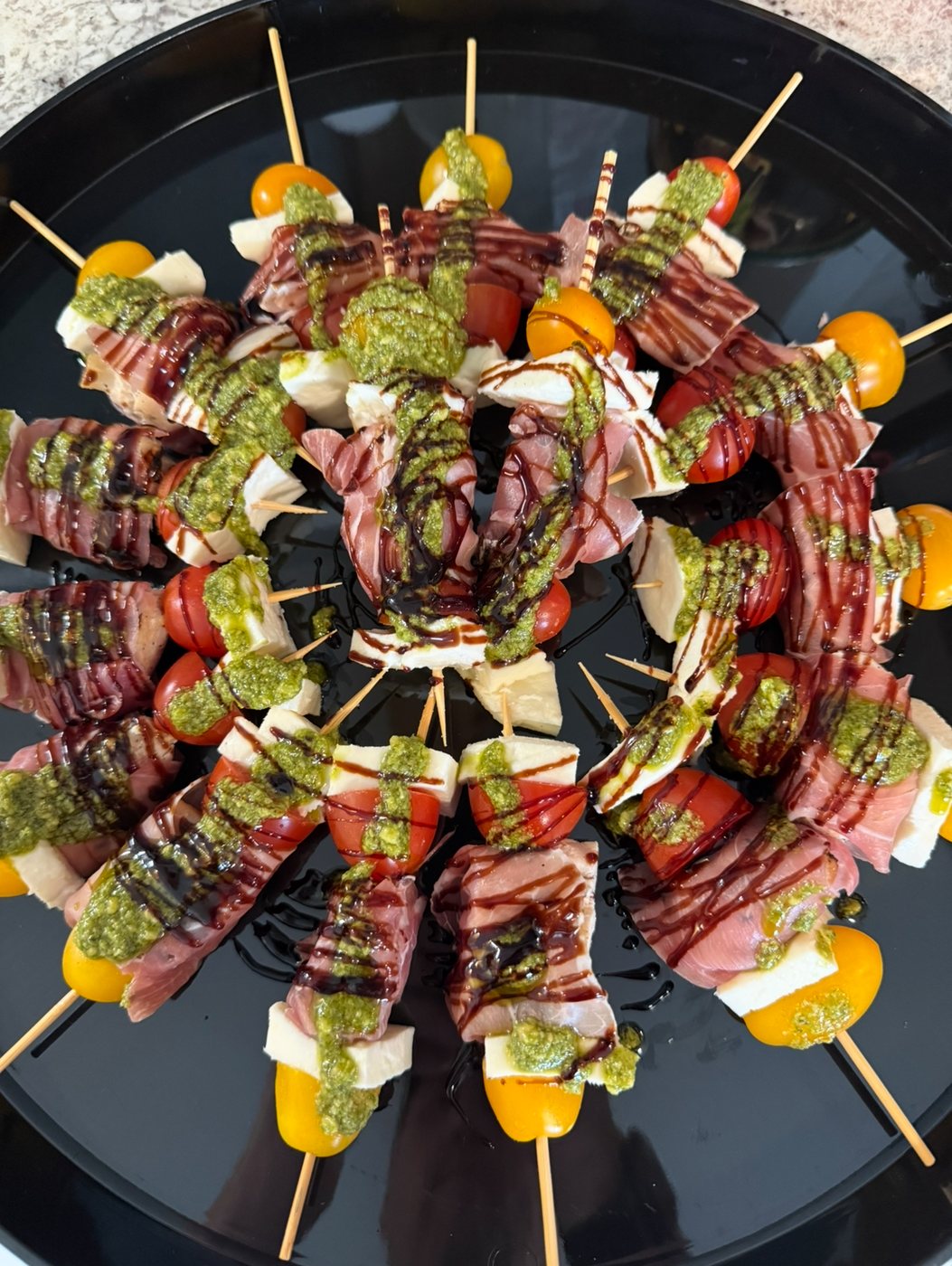 Prosciutto and mozzarella skewers with pesto and balsamic
