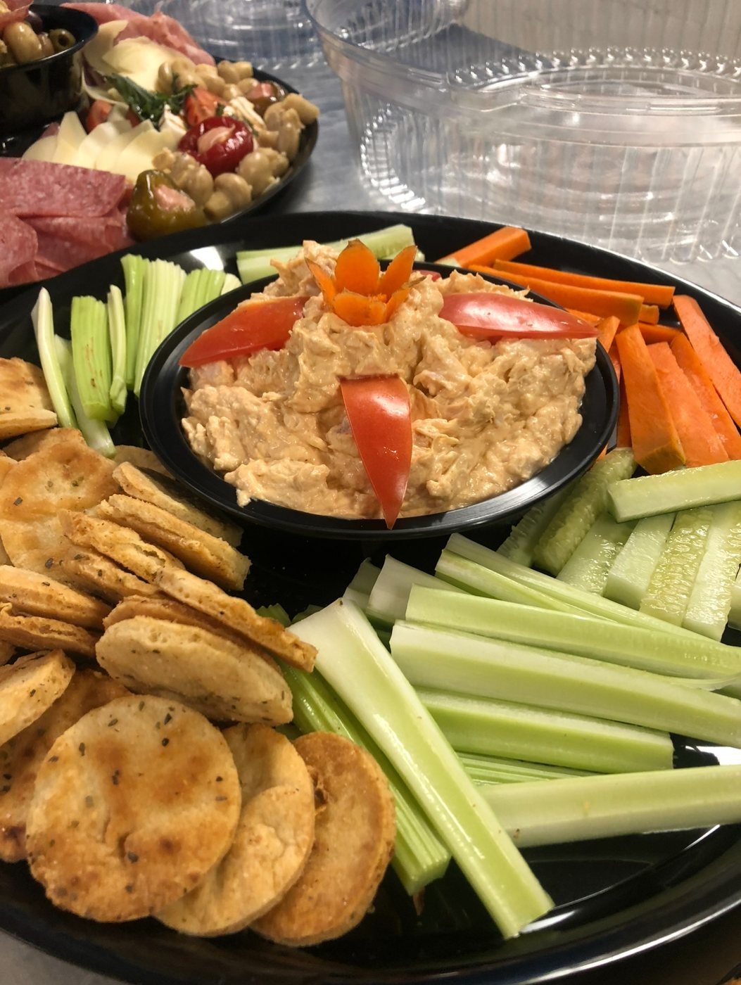 Buffalo chicken dip with celery, carrots, cucumber and pita chips