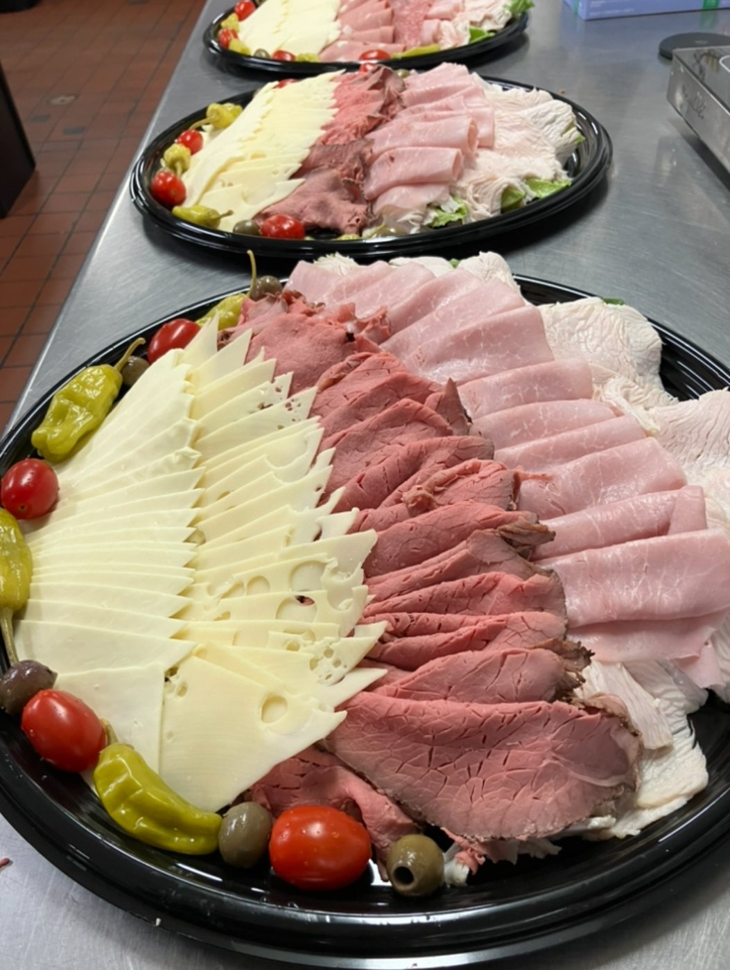 Deli platters with cheeses, roast beef, ham and turkey