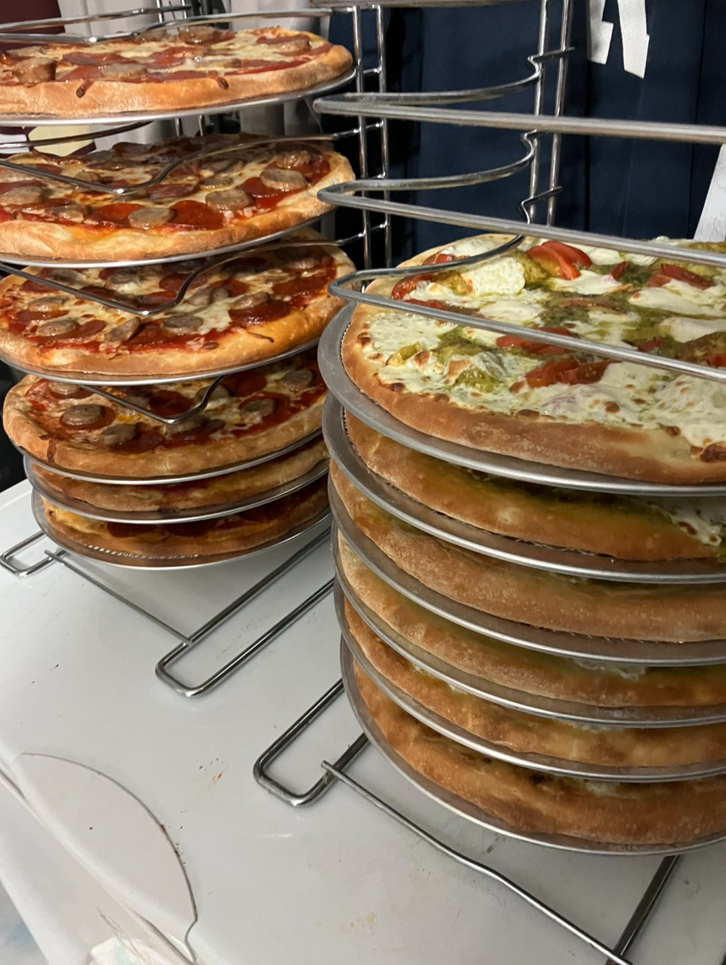 Fresh pizzas on a rack